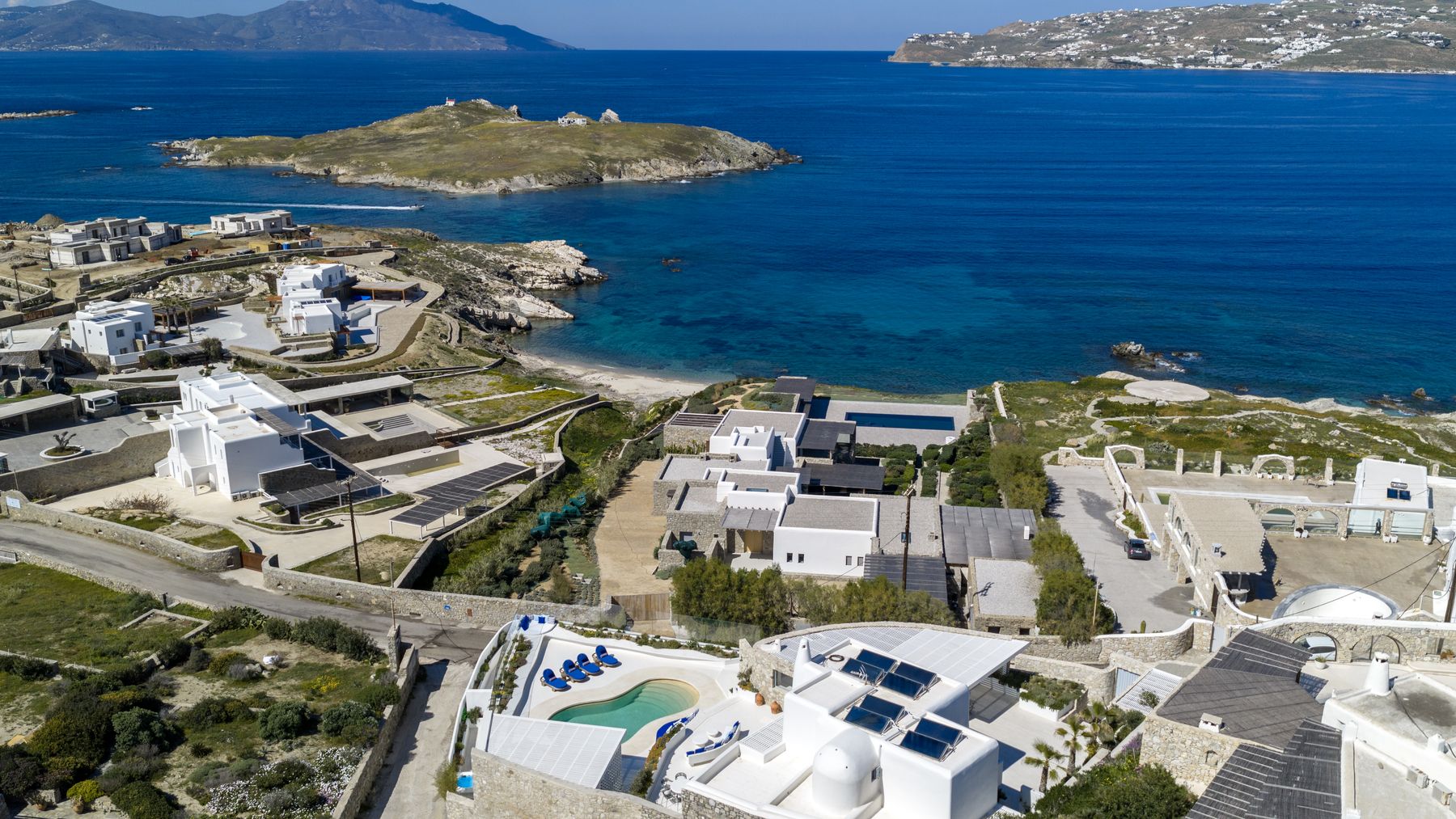 Aerial view over Kanalia towards the sea and a small island
