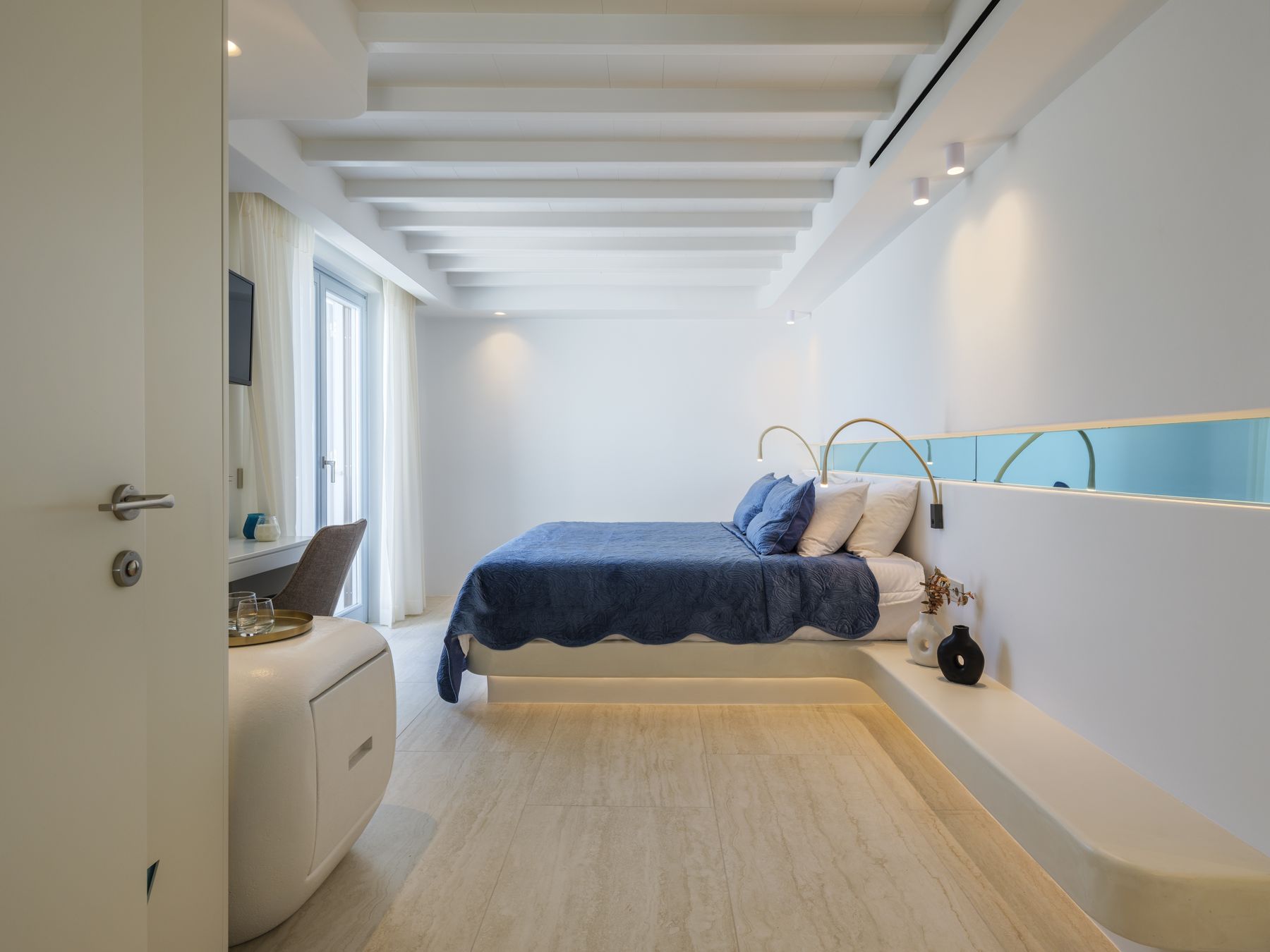 Bedroom with low platform bed and soft lighting