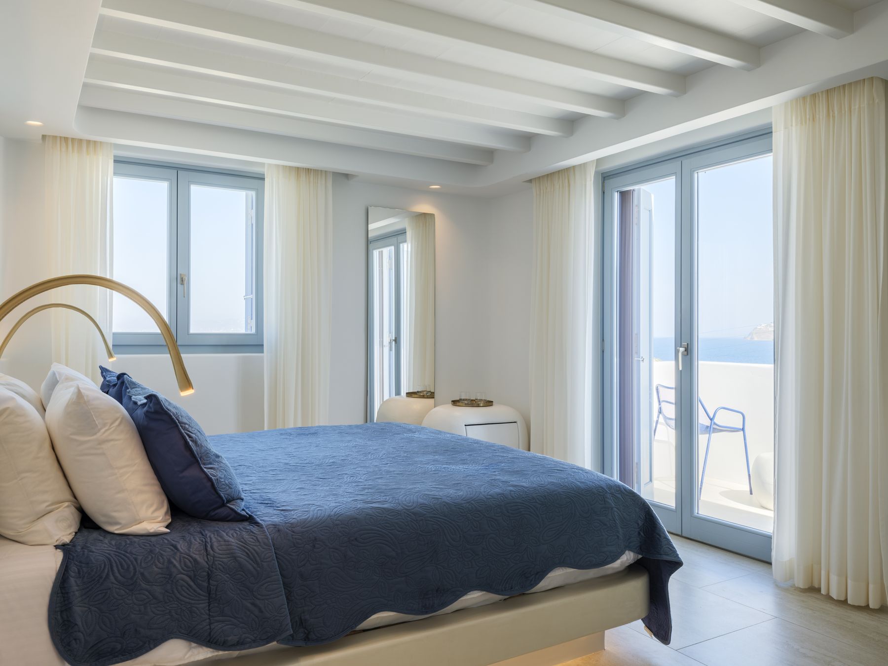 Bedroom with doors to a sea-view balcony