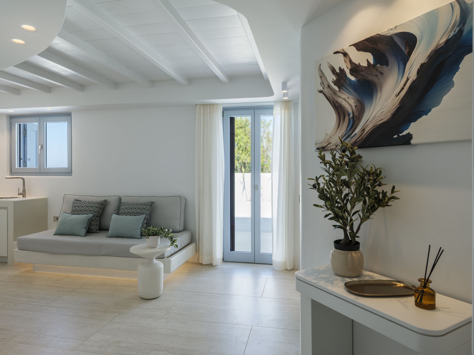 Suite 1 living area with sofa and artwork