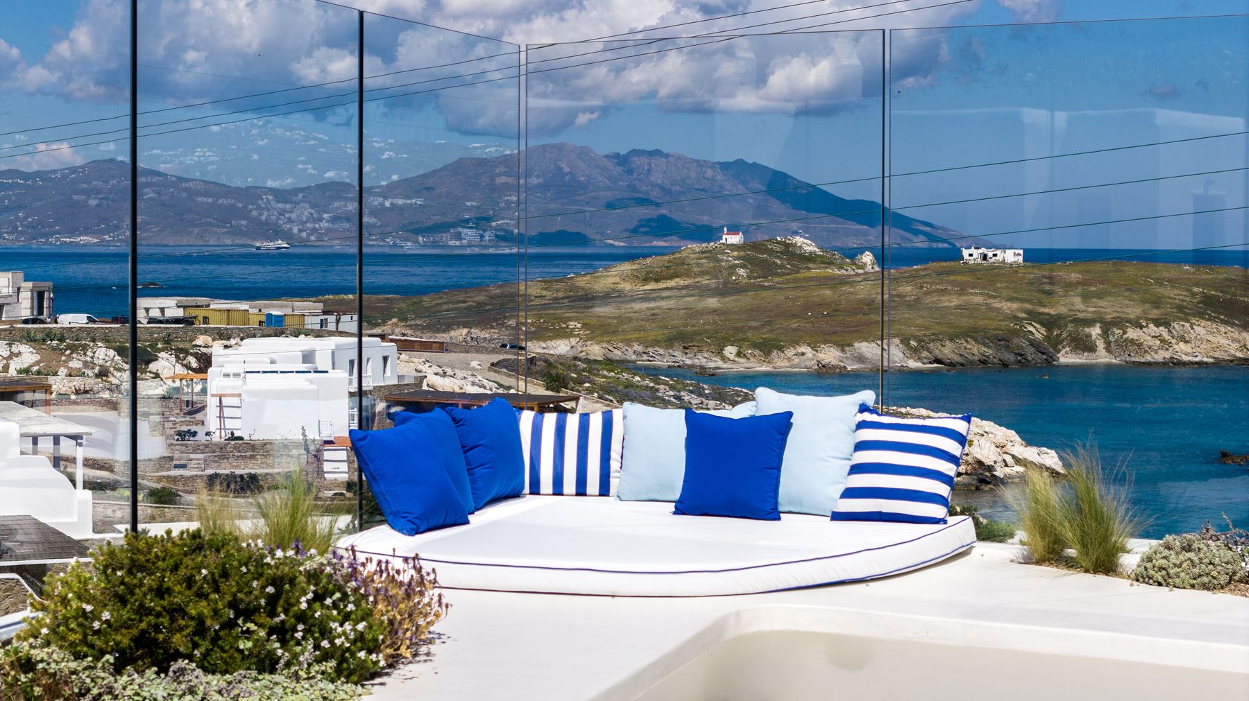Daybed with blue cushions and sea view